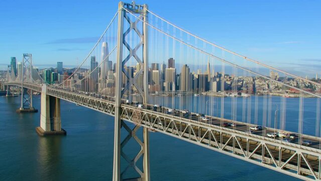 Aerial View Of The San Francisco Oakland Bay Bridge Full Of Traffic. Financial District Skyline In The Background. San Francisco, California. US.  Shot In 8K.