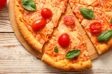 Board with tasty pizza margarita on white wooden background