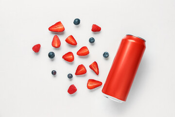 Composition with can of fresh soda and berries on white background