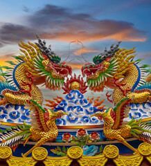 Colourful multicoloured dragon on top of a  temple in Patong Phuket Thailand. beautiful blue green...