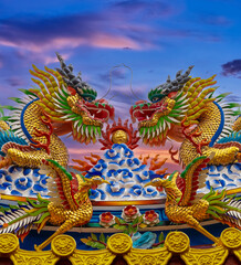 Obraz premium Colourful multicoloured dragon on top of a temple in Patong Phuket Thailand. beautiful blue green red of the scale dragons