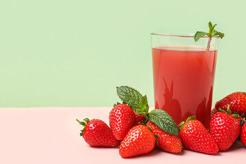 Glass of tasty strawberry juice on white table
