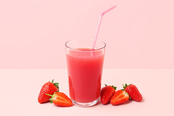 Glass of tasty strawberry juice on white table