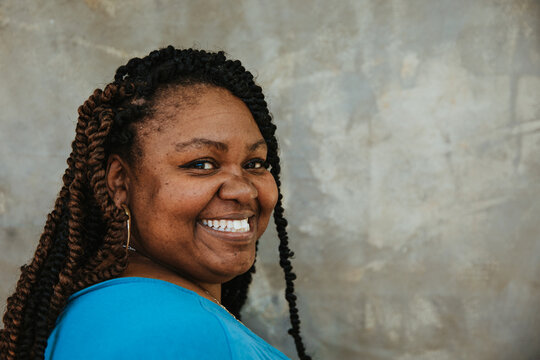 closeup side profile portrait of a smiling plus size afro latinx haitian american woman