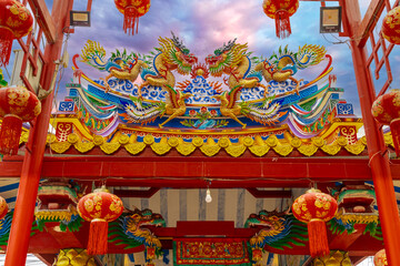 Colourful multicoloured dragon on top of a  temple in Patong Phuket Thailand. beautiful blue green red of the scale dragons