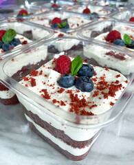 red velvet cake with chocolate dough, cream cheese filling and fruit topping like blueberry, raspberry and basil