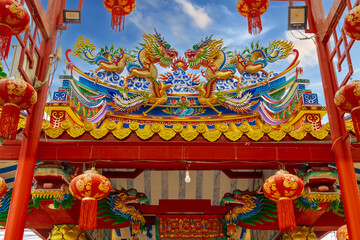 Colourful multicoloured dragon on top of a  temple in Patong Phuket Thailand. beautiful blue green red of the scale dragons