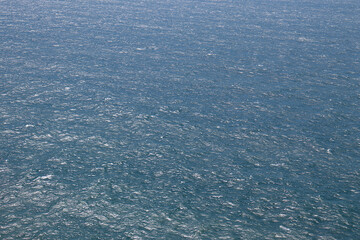 Smooth blue sea with reflections of sunlight.