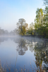 summer landscape with sunrise, fog and the river