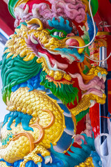 Colourful multicoloured dragon on top of a  temple in Patong Phuket Thailand. beautiful blue green...