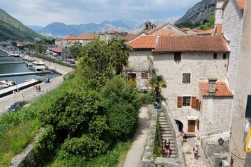 Fortress wall in Kotor, Montenegro. Kotor is a beautiful historic city on the Unesco list. Silhouettes of walking people on wall.
