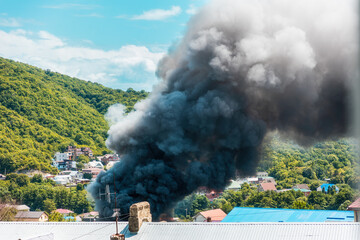 Fire. Close up of clouds of black smoke over a burning building. The concept of an emergency,...