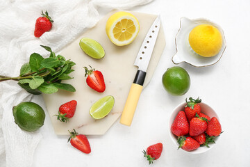 Composition with ripe strawberry, lime, lemon and mint on light background