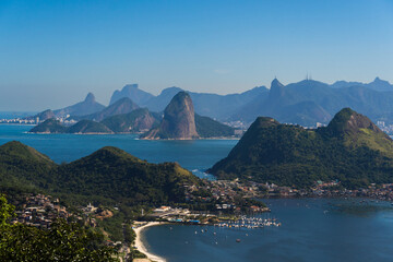 Beautiful view of Rio de Janeiro, Brazil seen from Niterói. With many hills in the background, Guanabara Bay, Jujuruba, Sugarloaf Mountain, Christ the Redeemer, beaches, pier with boats. Sunny day