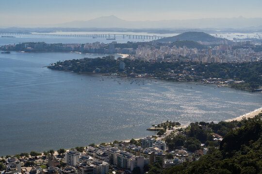Beautiful view of Rio de Janeiro, Brazil seen from Niter&oacute;i. With many hills in the background, Guanabara Bay, Rio Niter&oacute;i Bridge, Icara&iacute;, Charitas, beaches, pier with boats. Sunny day