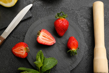 Ripe strawberry and mint on dark background, closeup