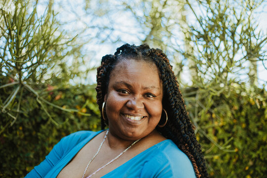 close up of plus size African American woman smiling with textured hair