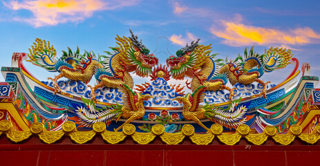 Colourful multicoloured dragon on top of a  temple in Patong Phuket Thailand. beautiful blue green...