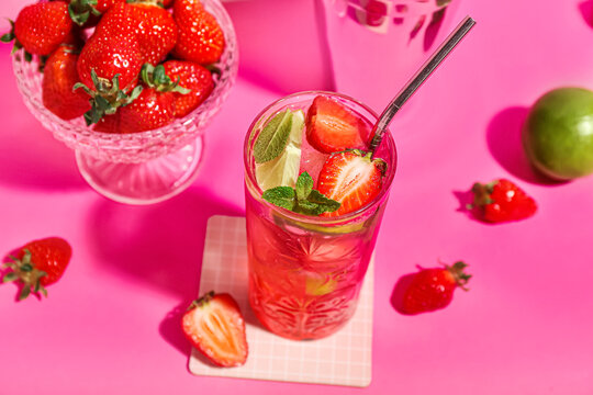 Glass Of Fresh Strawberry Mojito On Pink Background, Closeup