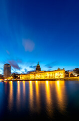 Fototapeta na wymiar Illuminated View of Custom House on the bank of river Liffey under blue skyline, Dublin, Ireland