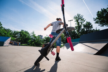 Wide-angle view of a professional bmx bike rider doing extreme sports in a skate park.