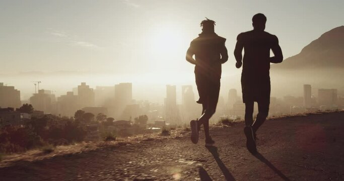 Exercise, running and silhouette with sports men outdoor for a cardio workout against a cityscape at sunset. Fitness, health and teamwork with runner athletes outside for endurance training together