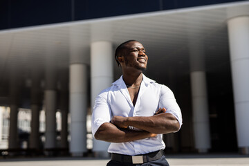 portrait of happy african man near building	