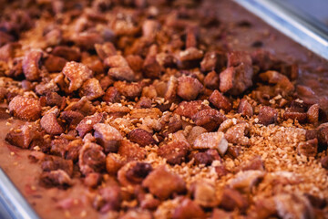 brazilian pork rinds, served buffet style, with onions and other vegetables, restaurant food