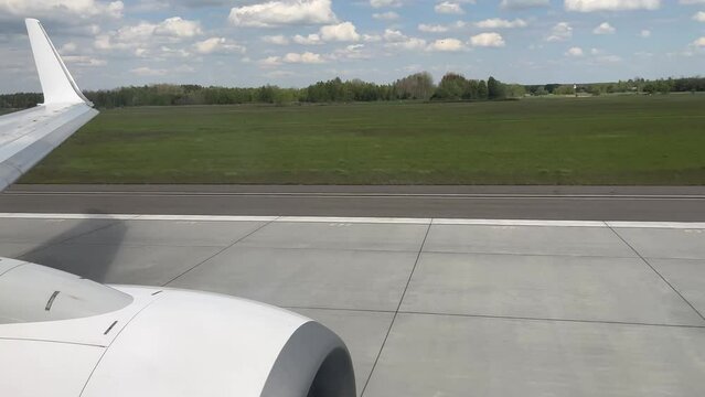 Take-off of the plane at the airport. View from the window of the aircraft.