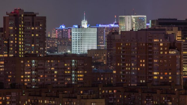 Building of the Government of the Russian Federation in Moscow at evening (White House) the view from the top timelapse. Aerial view from rooftop. Residential buildings with lights in windows around