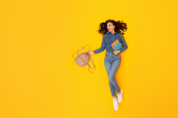 Cheerful Lady Student Holding Backpack Near Free Space, Yellow Background