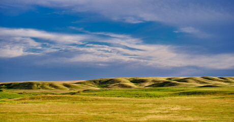 Rolling hills and fertile farmland makes a classic image of Canada's Bread Basket near Saskatchewan
