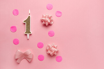 Number 1 on pastel pink background with festive decor. Happy birthday candles. The concept of celebrating a birthday, anniversary, important date, holiday. Copy space. Banner