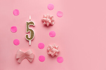 Number 5 on pastel pink background with festive decor. Happy birthday candles. The concept of celebrating a birthday, anniversary, important date, holiday. Copy space. Banner