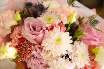 Bouquet of delicate flowers close-up, roses, chrysanthemums, eustoma. Flowers for a gift for a holiday, birthday, wedding, mother's day. A holiday card with space for text