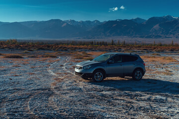 Car on the surface of a dried-up salt lake