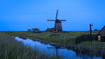 Fototapeta premium Ondermolen D windmill near Schermerhorn city in Netherlands during twilight.