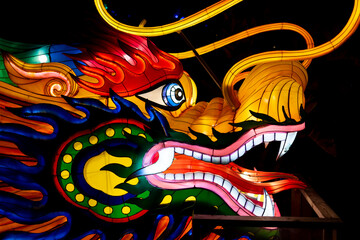 Colorful Dragon face decoration light up with colorful lights in the night at Chinese lantern festival in Orlando Zoo.