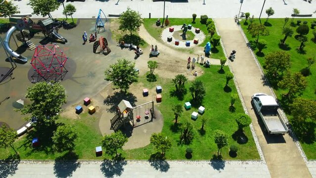 aerial photography of drones in park of Batumi Boulevard Lekha and Maria Kaczynski. This park has many facilities for children, as well as children's playground by sea on sunny day. View city Batumi