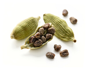 Cardamom pods with seeds isolated on white background with clipping path.