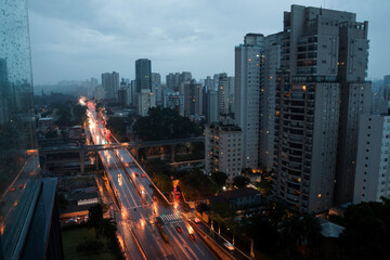 Sao Paulo city capital, Brazil at the end of a rainy afternoon. Lights from cars and buildings on...