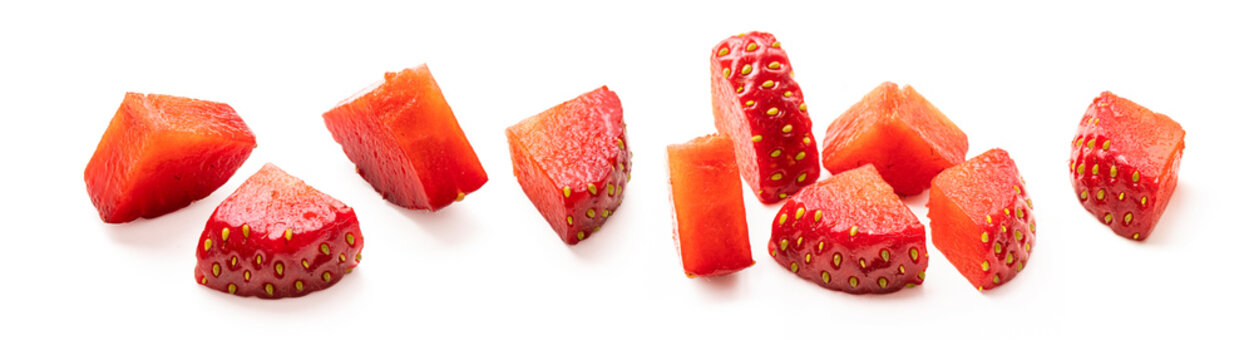 Set of cut strawberry pieces isolated on white background. Chopped strawberry close up. Collection of small pieces of fresh strawberries on white.