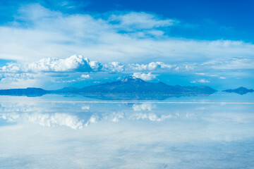 Uyuni Salt Flats. Altiplano, Bolivia. Rainy Season. Tunupa Volcano. Clouds Reflection on Water in Lake Surface.