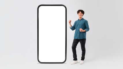 Happy Man Posing With Big Cellphone Gesturing Yes, White Background