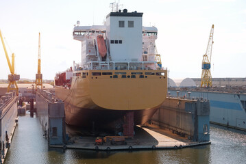 Oil chemical tanker in the dry dock during repairs. Annual safety inspection. Dry dock and repairs....