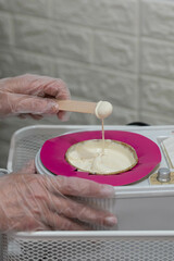 Professional cosmetologist beautician preparing hot wax for sugar depilation. Sugaring procedure.