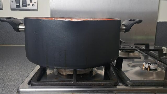 Ukrainian national dish red borsch on gas stove in saucepan