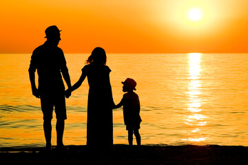 A happy family by the sea in nature silhouette weekend travel