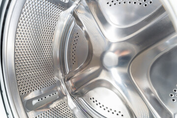 Inside of washing machine. Rotating inner tub. Material metal. Close-up of electrical household...