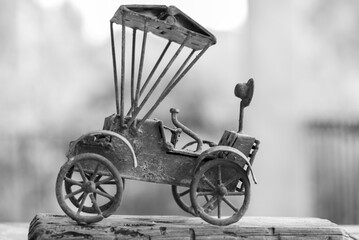 Antique rickshaw toy on wooden table with blur background. Old Car